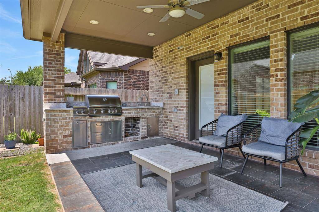 Ready to wind down or entertain your guests? Step out onto your extended covered back patio complete with full outdoor kitchen and swing!