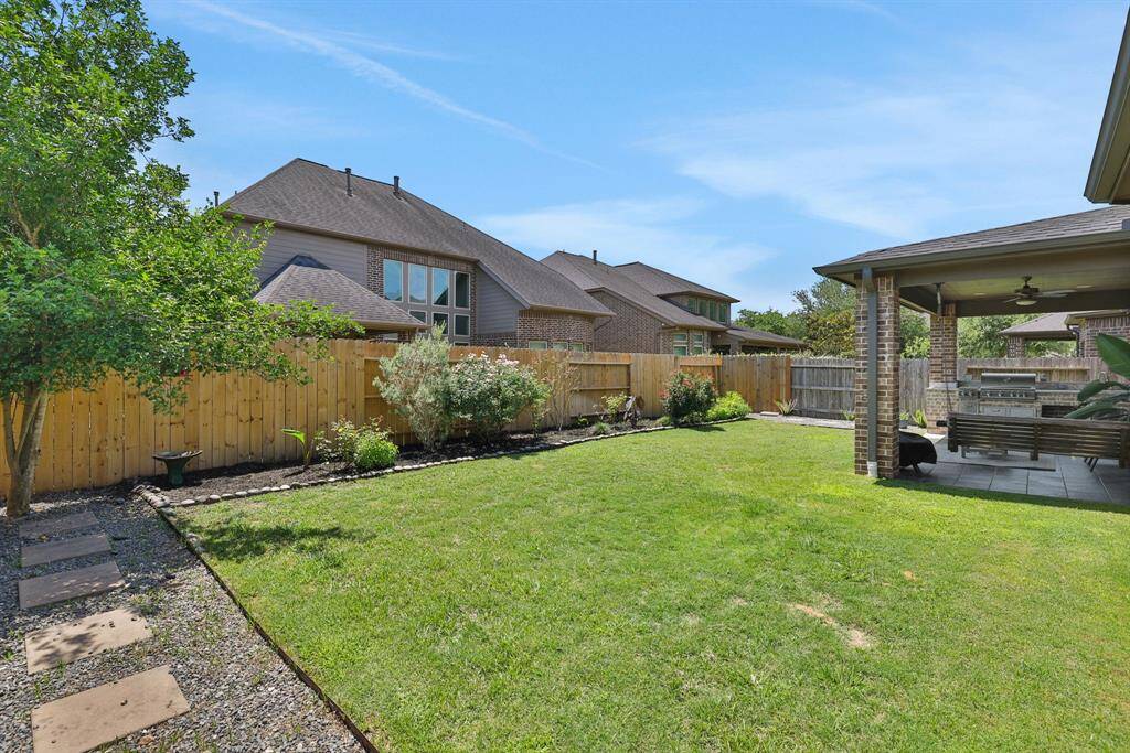 Backyard features simple, clean landscaping with French drains and a new fence on two sides!