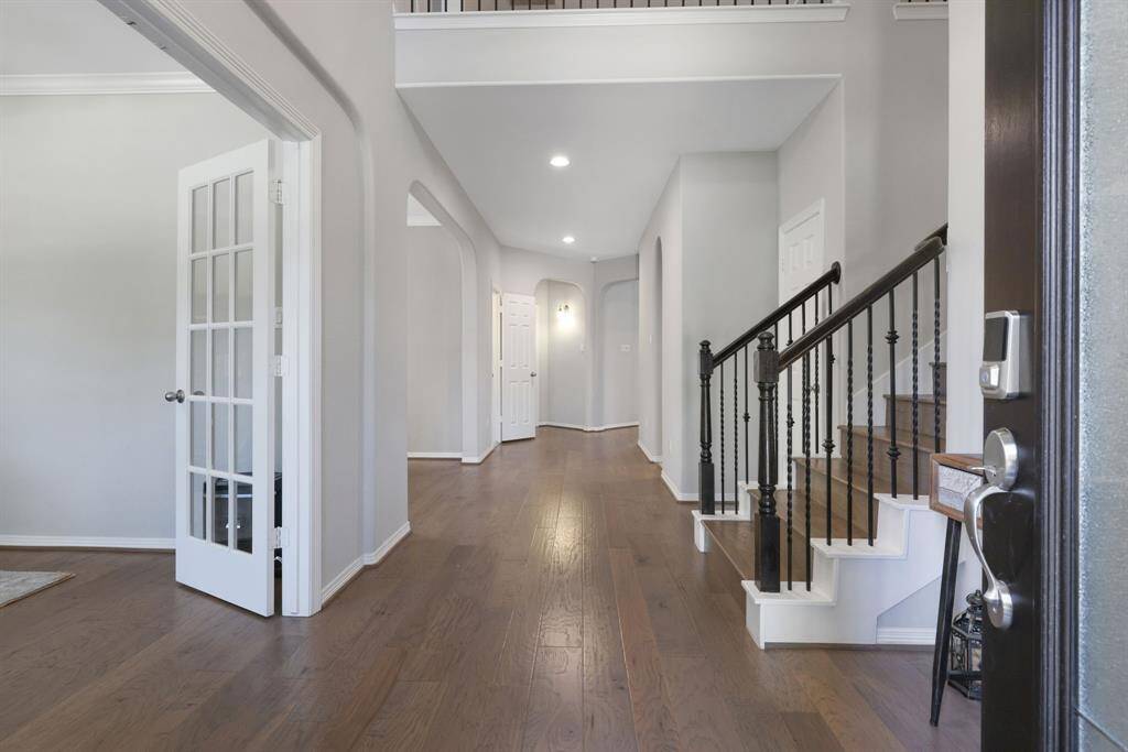 Upon entering, you'll find your home office immediately to the left with french doors and rich engineered wood floors throughout the main level