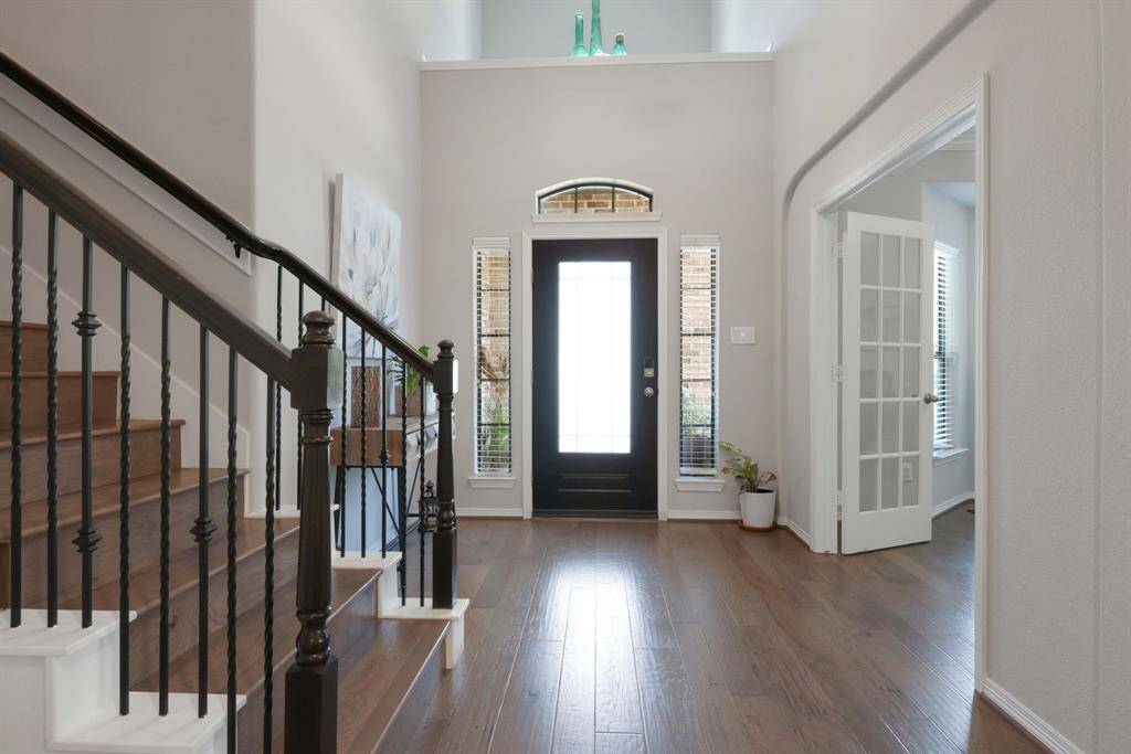Another view of the front door, office doors and stairs leading to second floor