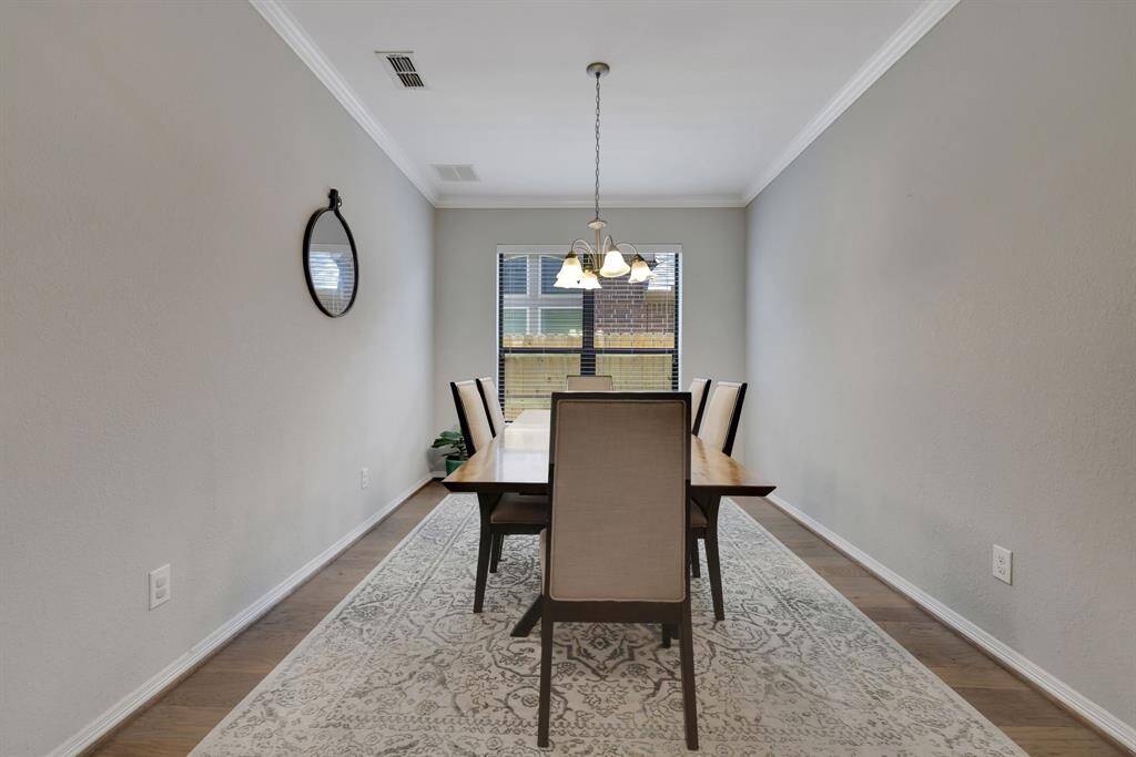 Down the hall is sizable formal dining room with large window offering additional natural light