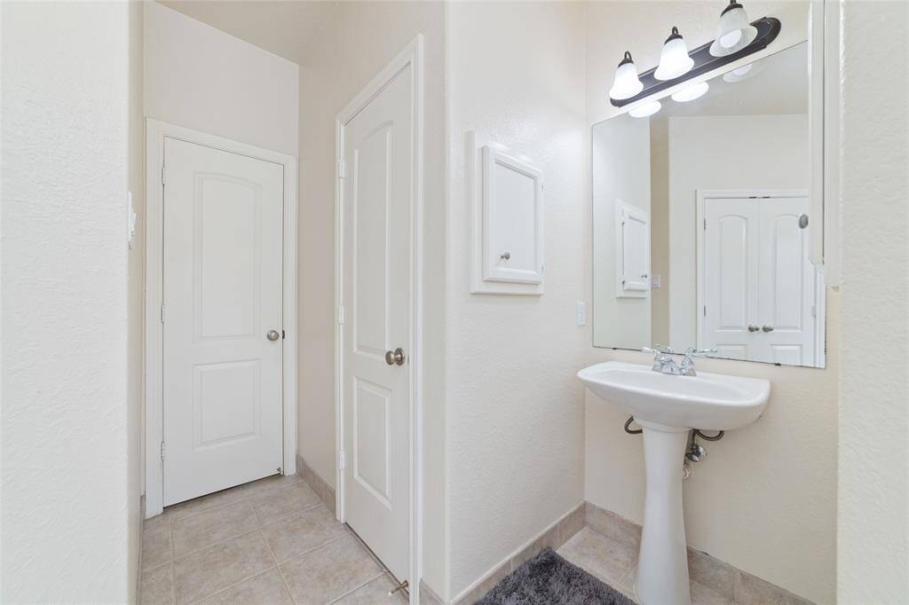 Primary bathroom with double closets, double sinks, and an oversized shower.