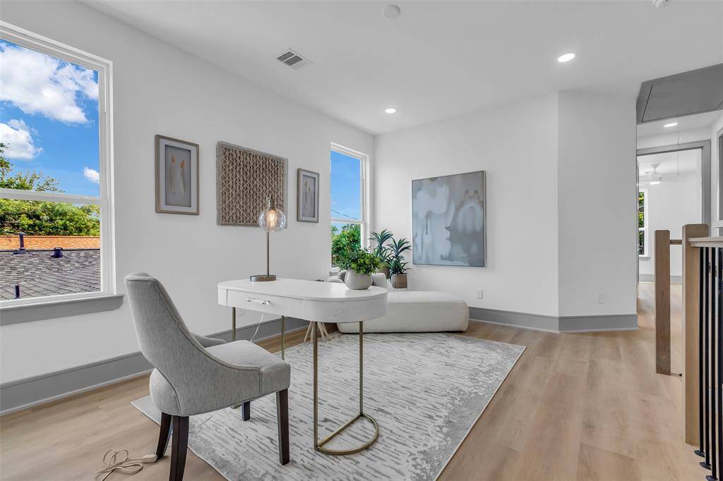 Another view of the flex space, featuring windows that overlook the neighborhood.