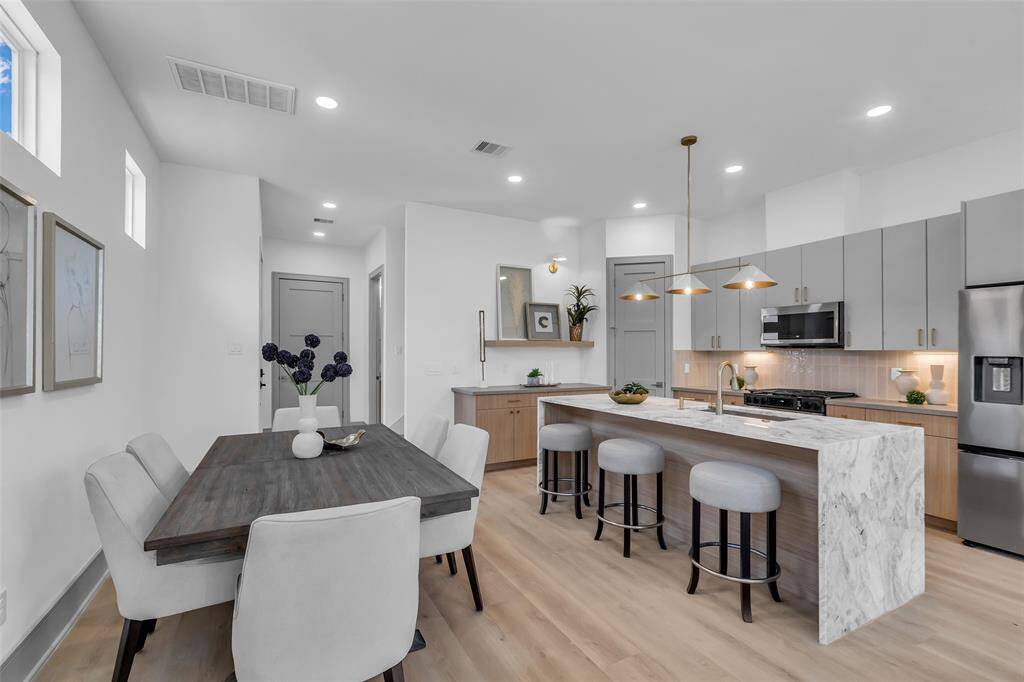 Welcome to the kitchen—ready for everyday cooking or entertaining with ease. It is well-equipped with stainless steel appliances, a gas range.