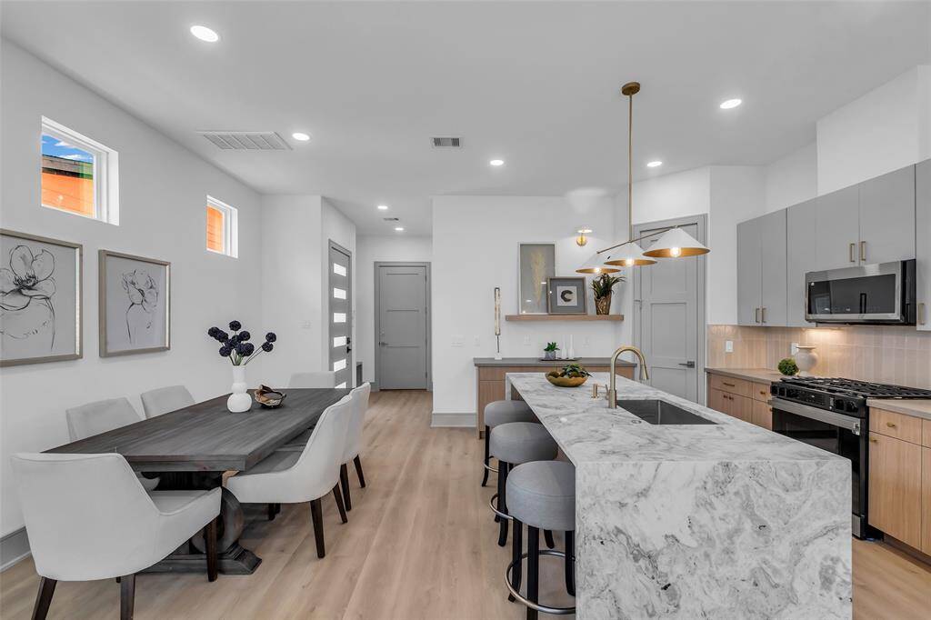 The dining area sits just in front of the kitchen, creating a seamless flow for meals and gatherings.