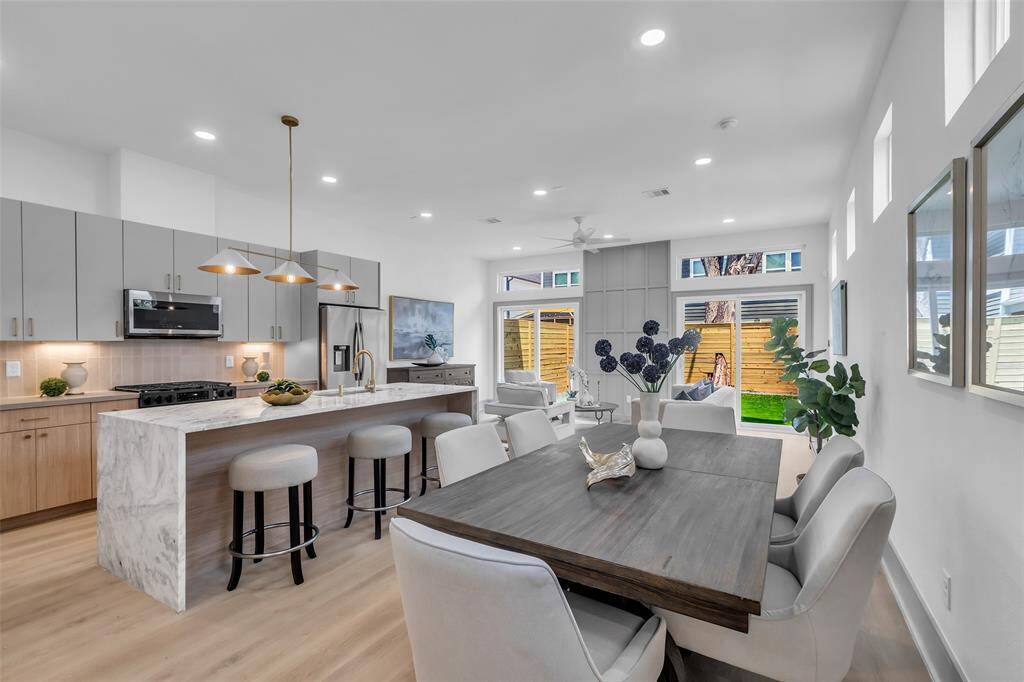 A view highlighting the seamless flow between the kitchen, dining, and living areas.