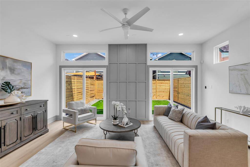 The large glass doors fill the space with bright natural light, creating an open and inviting feel.