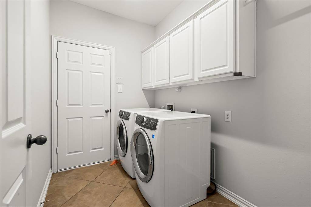 Laundry room downstairs with room for a fridge