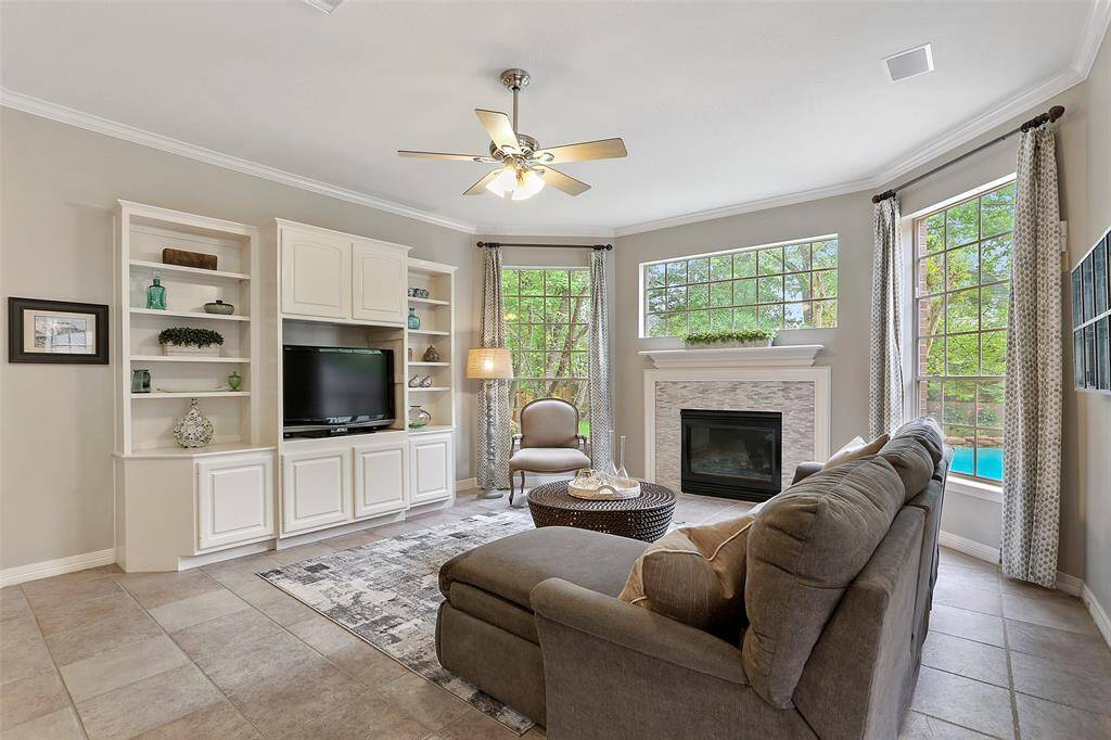 Built in shelving and cabinets, neutral paint and drapes finish this space nicely. Built-in speakers.