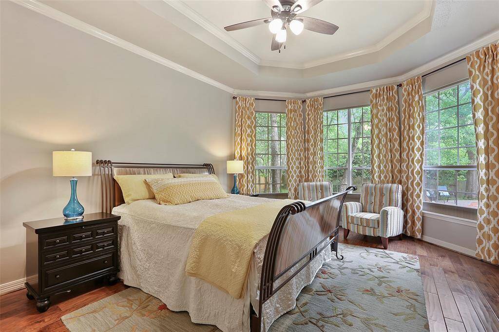The primary bedroom is tucked in the back of the home overlooking the lush private back yard. Tray ceiling, crown molding, wood flooring and large windows complete this room.