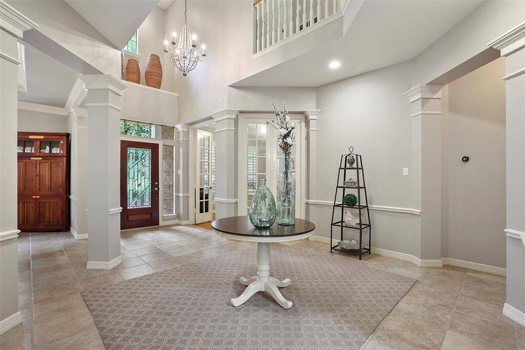 The grand entry is light and airy. A gorgeous chandelier welcomes guests in the foyer. Fresh neutral paint throughout this pristine home.