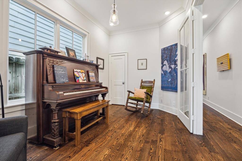 Framed by glass doors and featuring a spacious closet, this flexible room sits just across from the powder room - ideal as a home office, creative space or optional 5th bedroom.