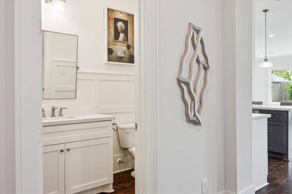 Crisp millwork and a clean modern vanity give the powder room a tailored feel.