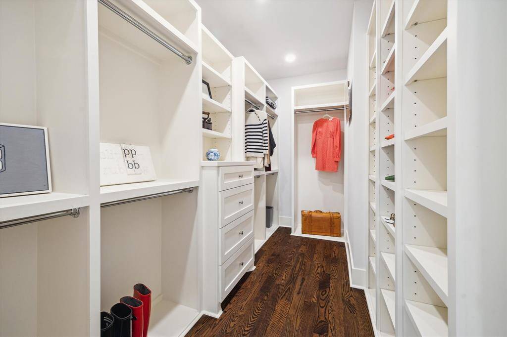 The first closet maximizes organization with extensive built-ins, double hanging rods and cubby style shelving ideal for showcasing shoes, bags and accessories.