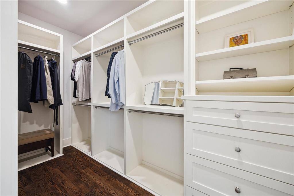 The second closet also features drawers, open shelving and double hanging rods