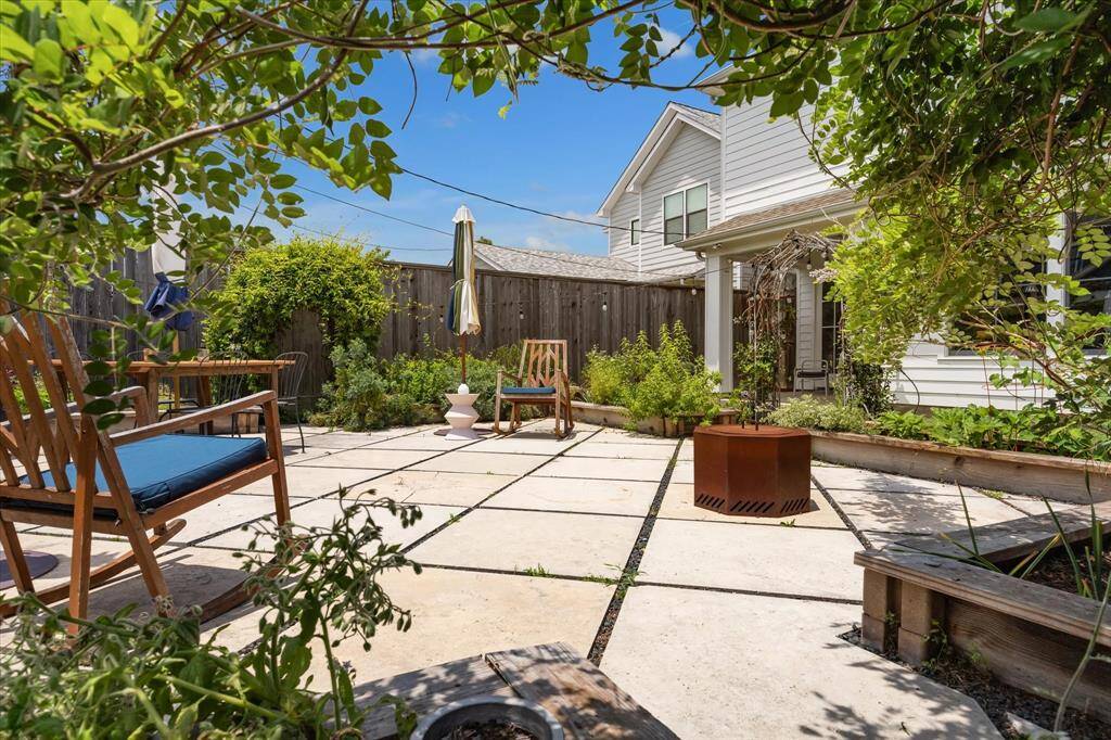 Framed by flourishing greenery, this thoughtfully designed backyard is the perfect space to relax, entertain or lose yourself in the quiet work of growing.