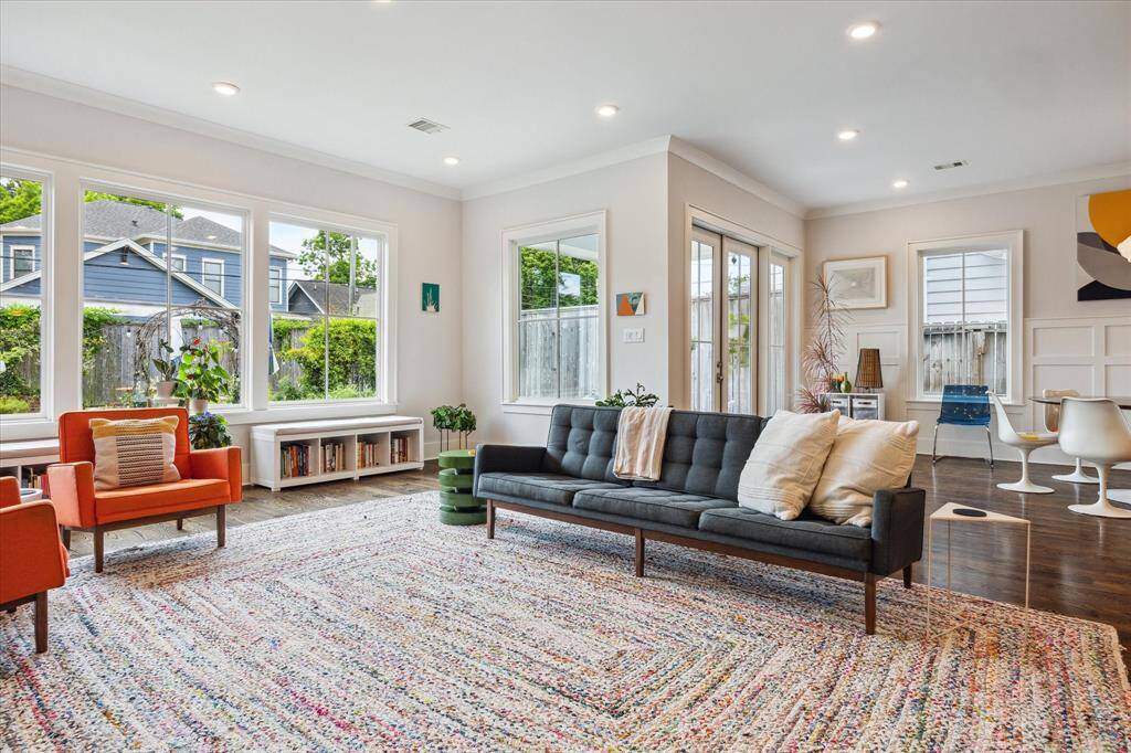 Bathed in natural light, the living room offers effortless flow to the backyard through glass doors