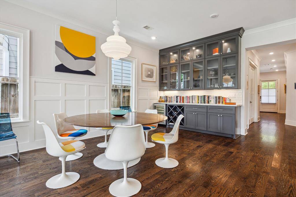Perfect for hosting, this stylish dining space features a built in butler's bar with glass front cabinets, built in wine storage and a beverage fridge.