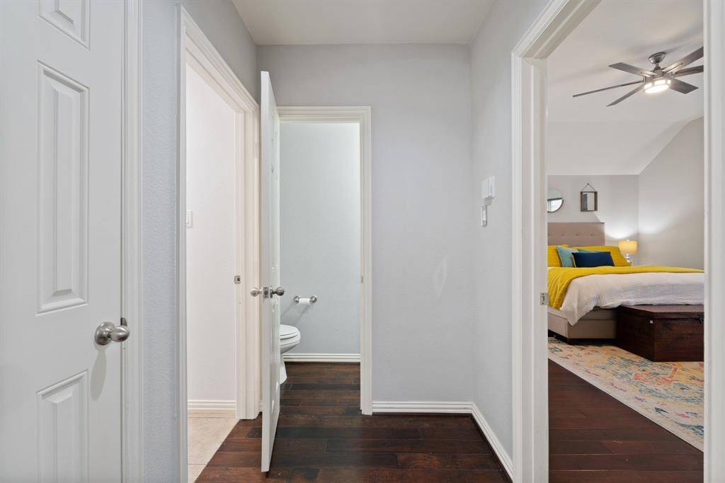 To the left is the laundry room and access to the garage. To the right is the primary bedroom.
