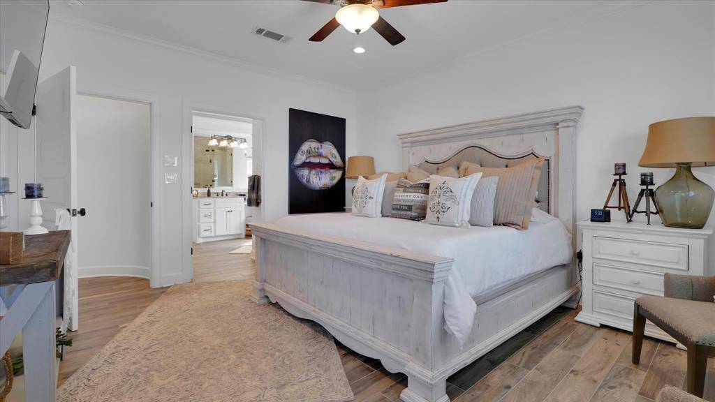 The primary bedroom with en suite bathroom is located just off the kitchen area and provides a cozy retreat to end your day relaxing in.