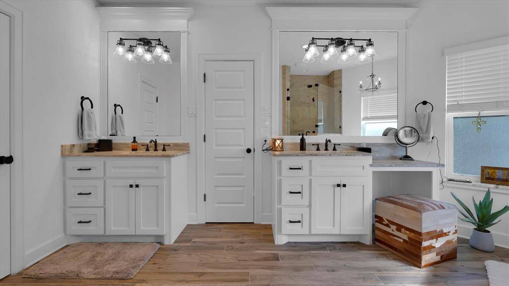 Dual vanities and abundant light makes this chic bathroom a serene retreat. Perfect for mornings where everything finally goes right—even your hair!