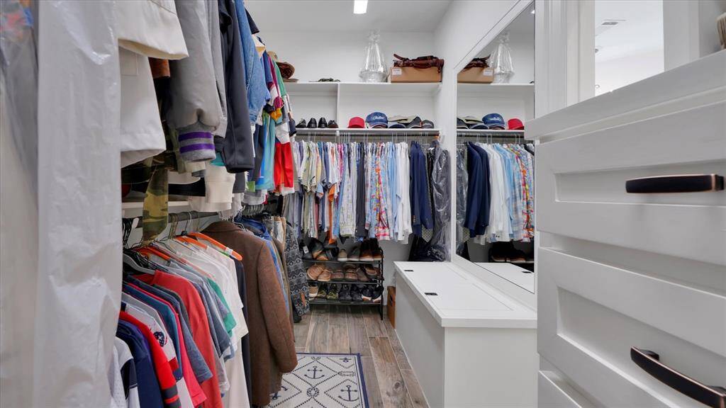 Step into your wardrobe wonderland! This spacious, organized closet in the primary suite offers ample room for your entire collection, complete with stylish shelving and built in dresser.