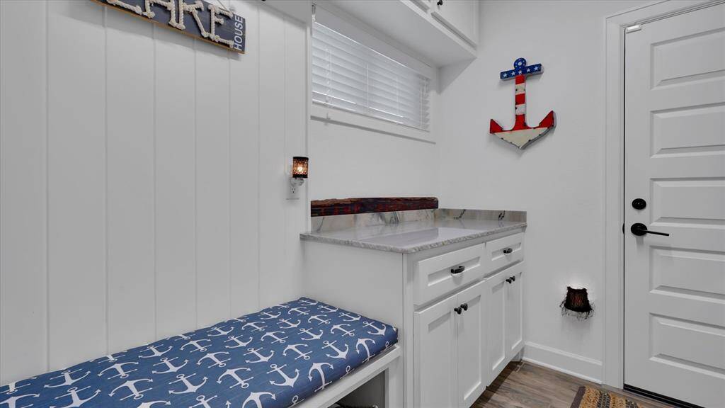 Utility room, leading to the garage, has extra counterspace and a bench to unload as you walk in to the house.