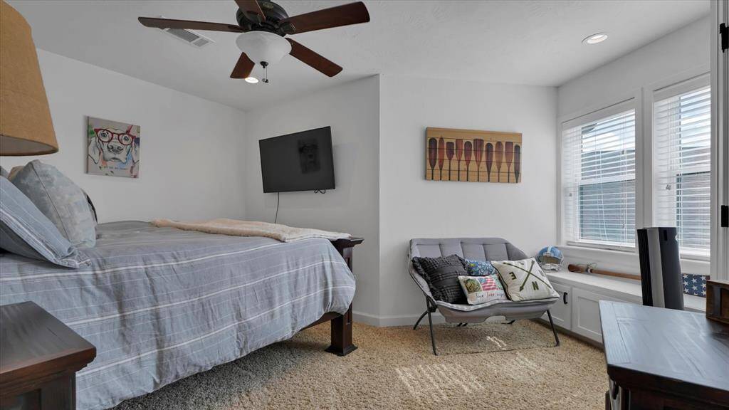 Guest room has a window bench and natural light, perfect for relaxing or entertaining. The shape of the room encourages a sitting area separate from the sleep area.