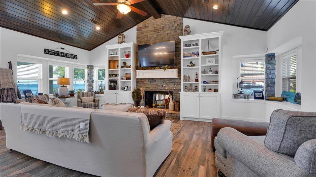This is where lake breezes meet cozy living spaces! The wood ceilings and flooring add the rustic charm to this lake shore retreat.