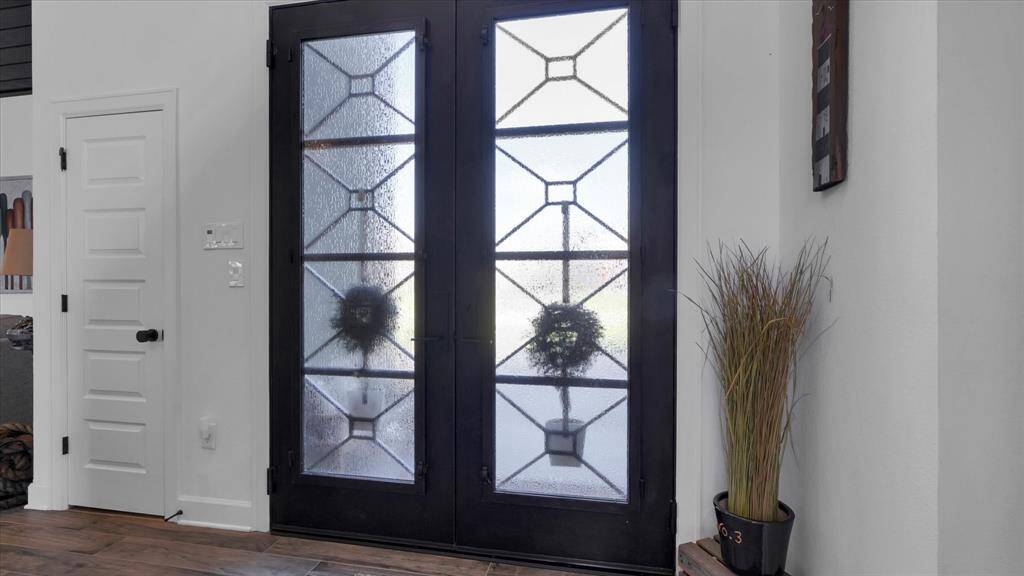 Welcome guests with elegant iron-accented doors with privacy glass that will brighten the area with filtered light.