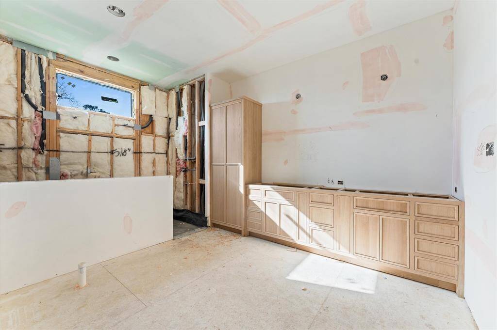 Primary bathroom includes large shower with bench, 67" soaking tub, dual sinks, custom inset white oak cabinets and quartz countertops. *Photos taken in mid-March*