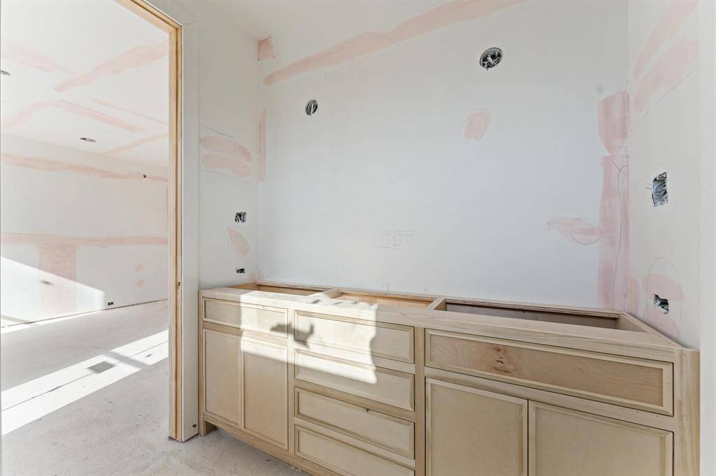 Bath 2 has access to game room and bedroom 2; includes quartz countertops, custom inset cabinetry and shower. *Photo taken in mid-March*