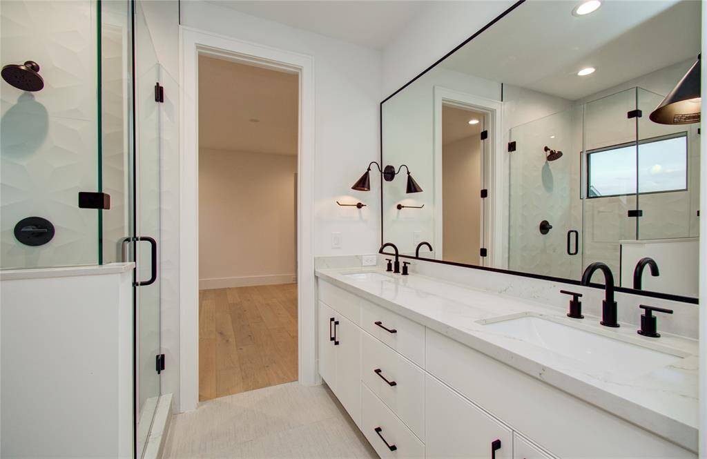 Bath with dual access to bedroom and game room. *Photos from a previous home by the same developer, selections and floor plans may vary.*