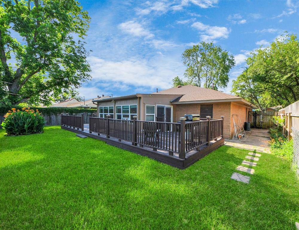 Enjoy outdoor living on the expansive wood deck, perfect for grilling, entertaining, or relaxing under the shade of mature trees. The beautifully maintained lawn provides plenty of space for pets, kids, or gardening.