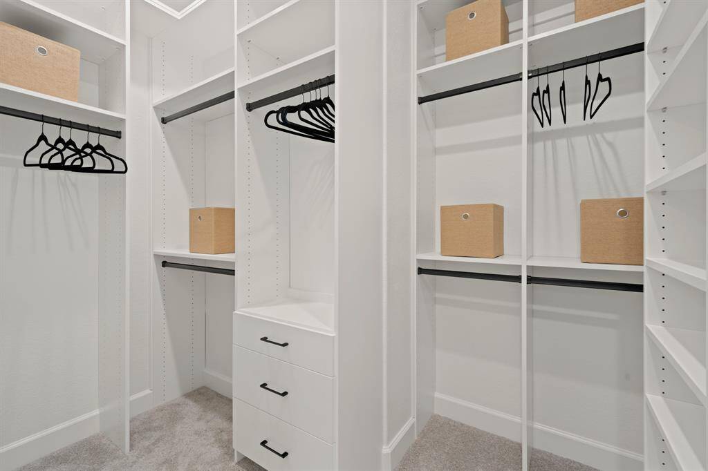 Step in to part of the primary closet! It's been finished with custom built ins and drawers, maximizing storage space!