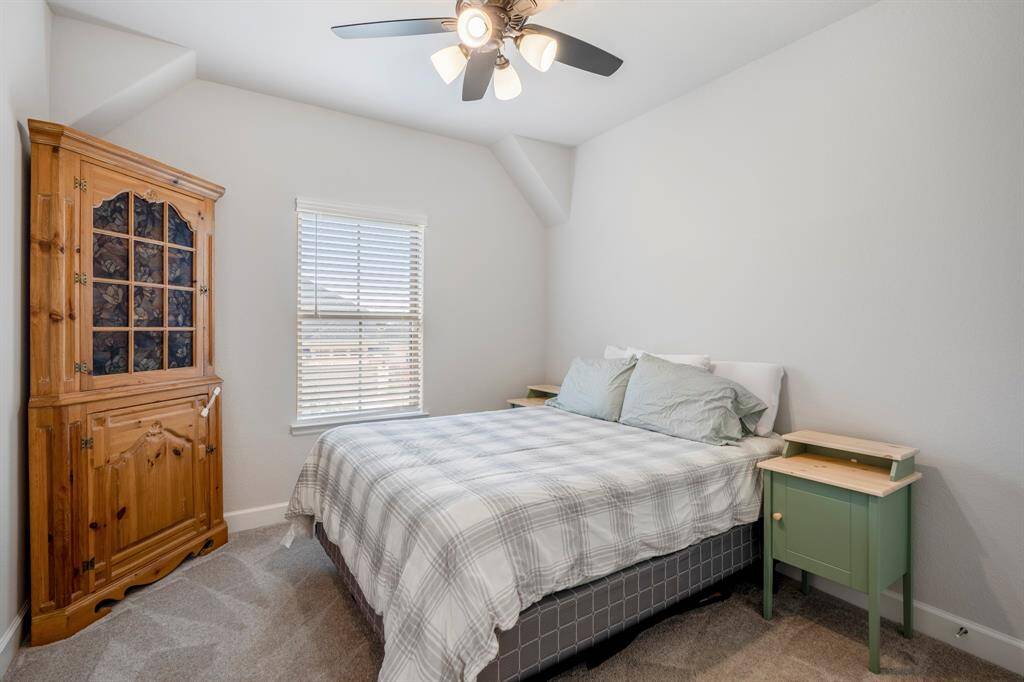 The final of the secondary bedrooms with plush neutral carpet, neutral paint, natural light, and spacious closet.