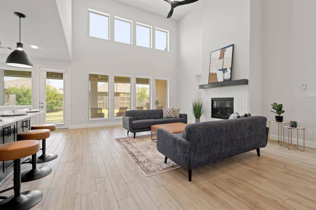 Gather the family and guests together in your huge living room! Featuring high ceilings, dark stained ceiling fan, gorgeous wood tile floors, and the perfect open layout!