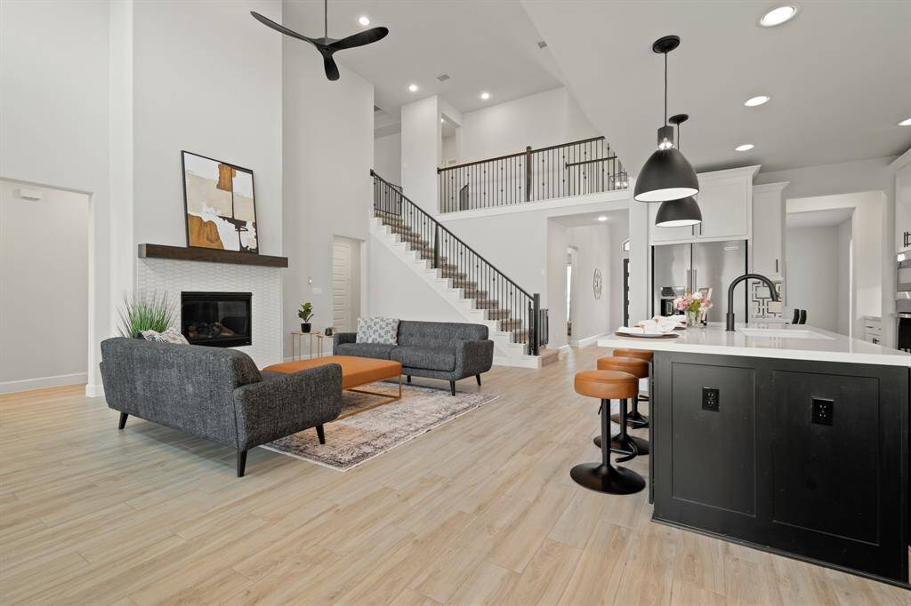 Whether it's a simple night in or entertaining family and friends, this home has ample open space for everyone to enjoy! You'll love cozying up by the fireplace featuring a modern tile surround and stained wood mantle.