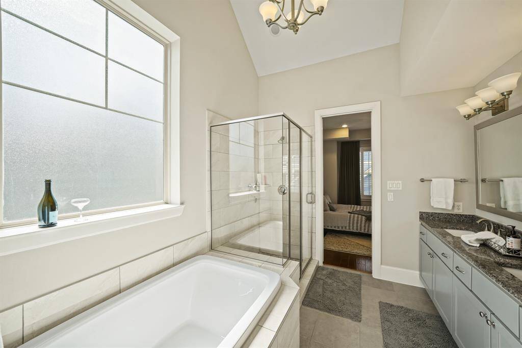 Primary Bathroom: Luxurious primary bathroom with a soaking tub and walk-in shower, providing a spa-like experience.