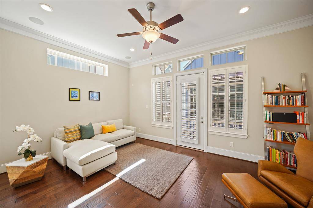 Living room with soaring ceilings and abundant natural light, ideal for both entertaining and relaxation.
