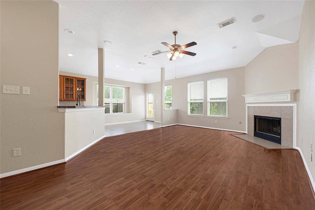 Versatile secondary bedroom with laminate floors and large window—ideal for a nursery, workout space, or craft room.