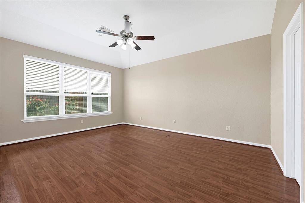 Enjoy backyard views from the large windows in this serene and private primary suite.