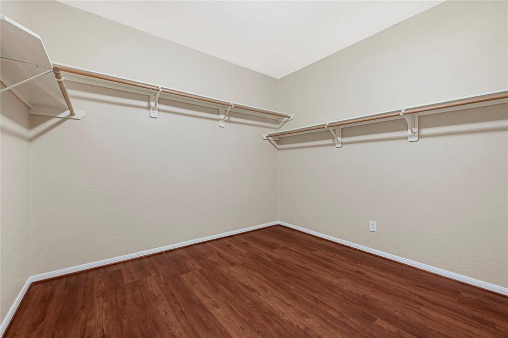 Huge walk-in closet with built-in shelving - plenty of room for all your wardrobe essentials.