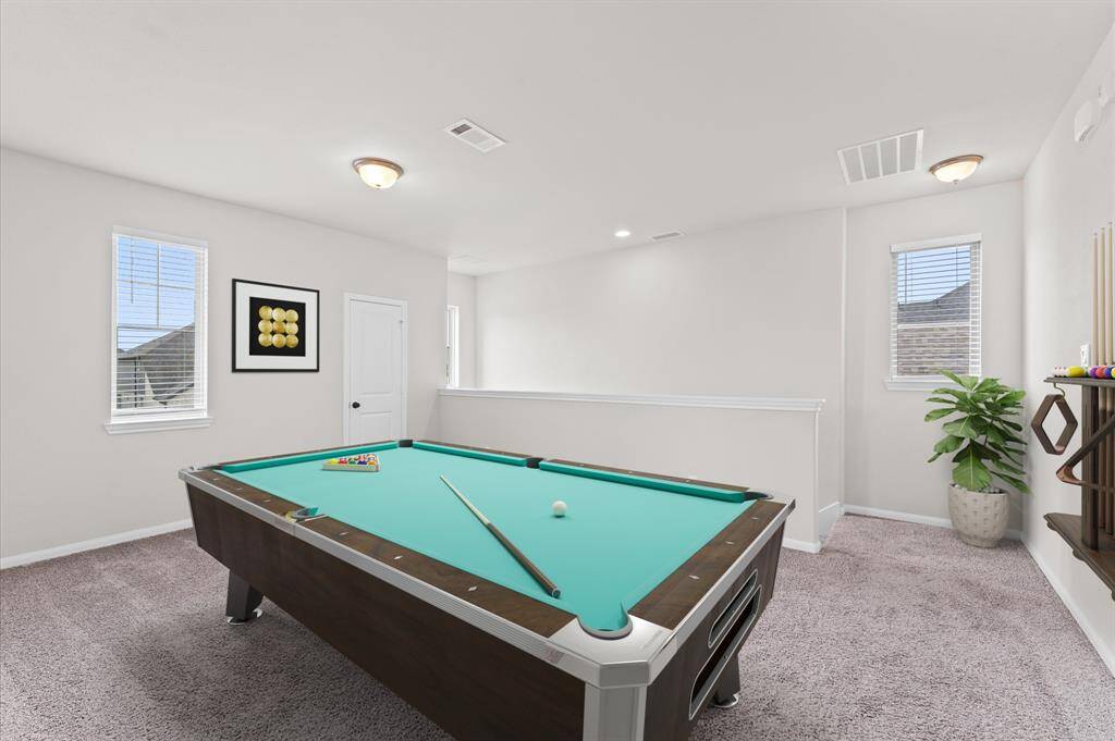 The upstairs game room provides a versatile space for entertainment or relaxation. Whether used as a playroom, media area, or hobby space, it’s perfect for any lifestyle.