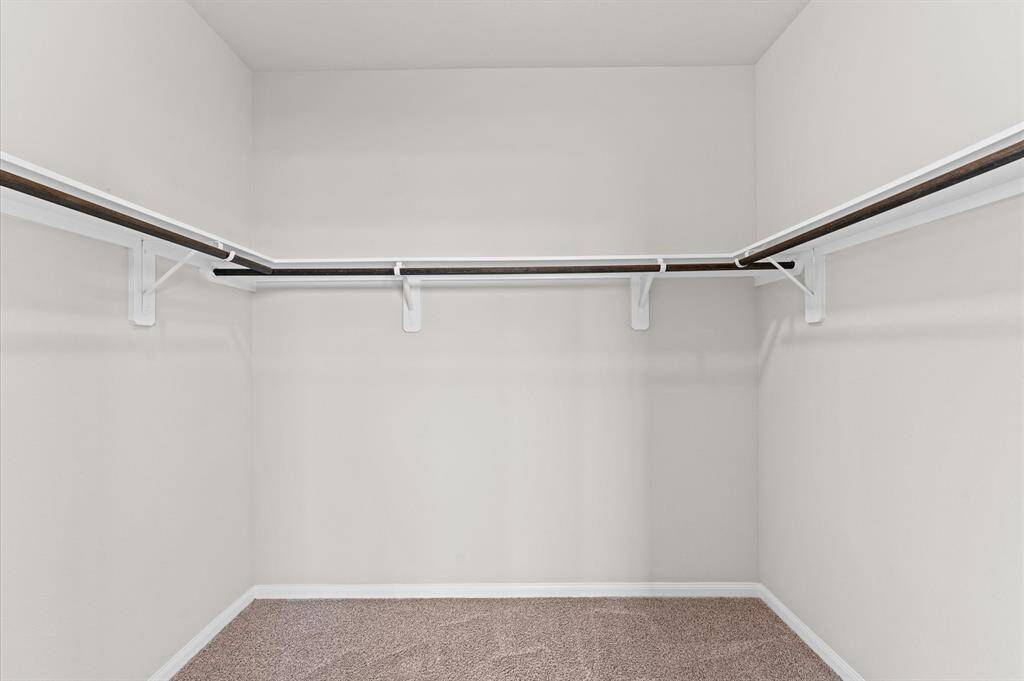 The walk-in closet provides ample storage, keeping everything neatly organized.