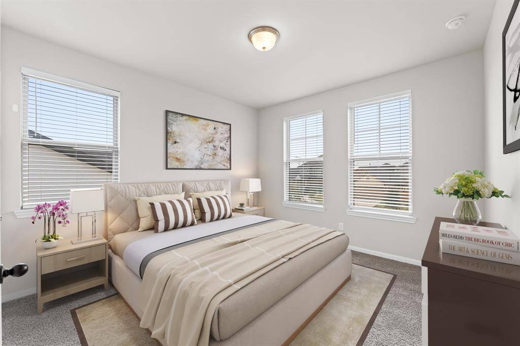 Bright and welcoming, this third bedroom is adorned with plush carpet flooring that invites relaxation. Ample windows provide a refreshing flow of daylight, creating a cheerful atmosphere throughout the day.