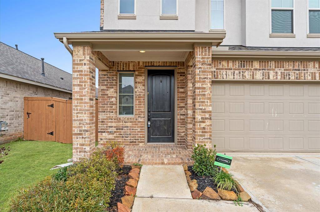 A charming entryway sets the tone for the warm and inviting interiors, with a well-manicured front yard adding to its appeal.