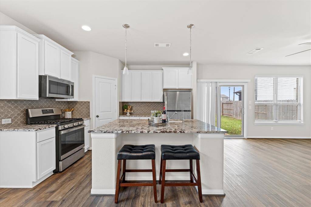 Designed for both function and style, the kitchen features a huge island, perfect for meal prep or casual dining.