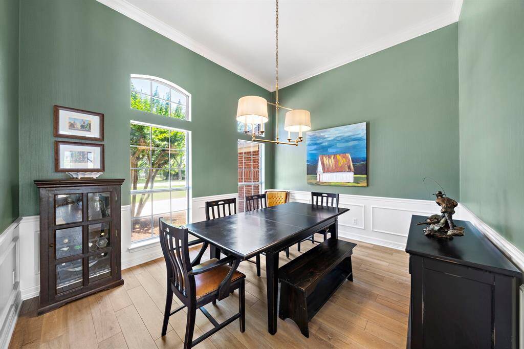 The dinning room features fresh paint and custom lighting.