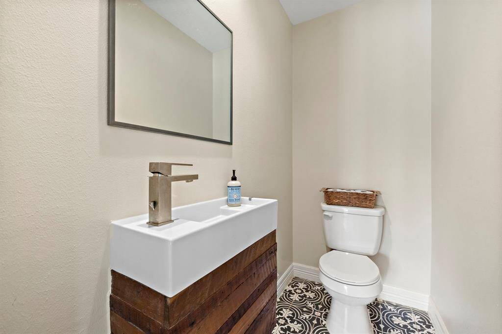 Guest half bathroom located off the game room.